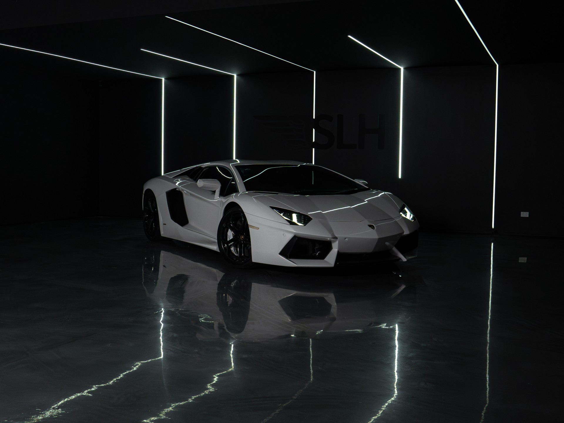 Luxury sports car parked in a dark premium showroom